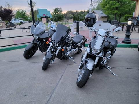 Two riders seated on white touring motorcycles.