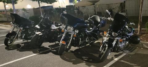 A row of motorcycles parked outside a building at dusk.