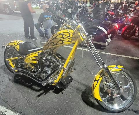 A yellow motorcycle with an extended front fork.