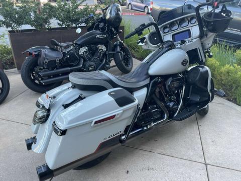 A white touring motorcycle parked beside a black motorcycle.