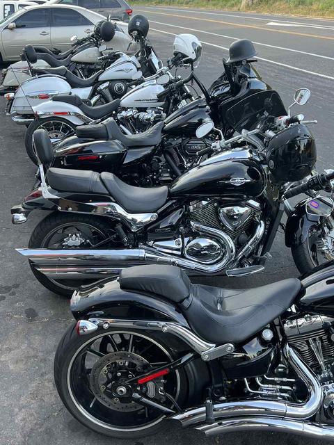 A close view along a row of parked motorcycles.