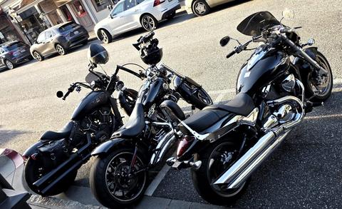 Two black motorcycles parked side by side.