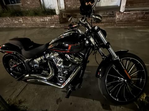A black motorcycle photographed outdoors at night.